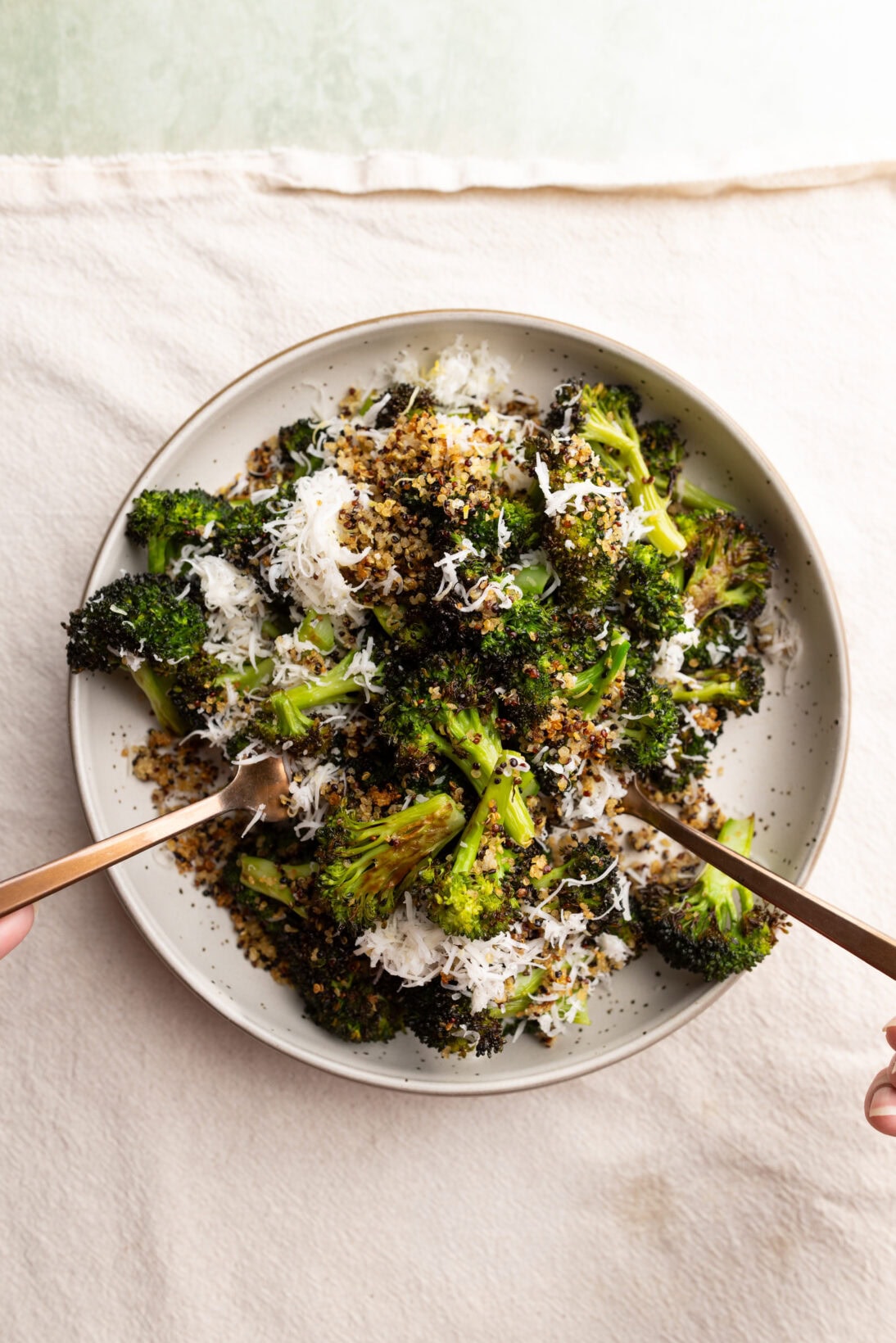 tossing a roasted broccoli salad.