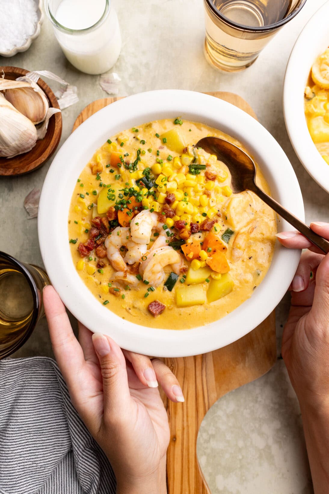 taking a spoonful of cajun shrimp and corn chowder