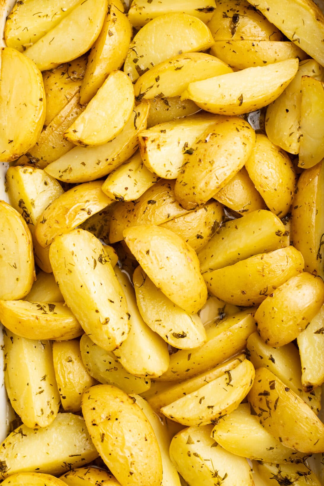 Finished, cooked greek lemon potatoes in a baking dish.