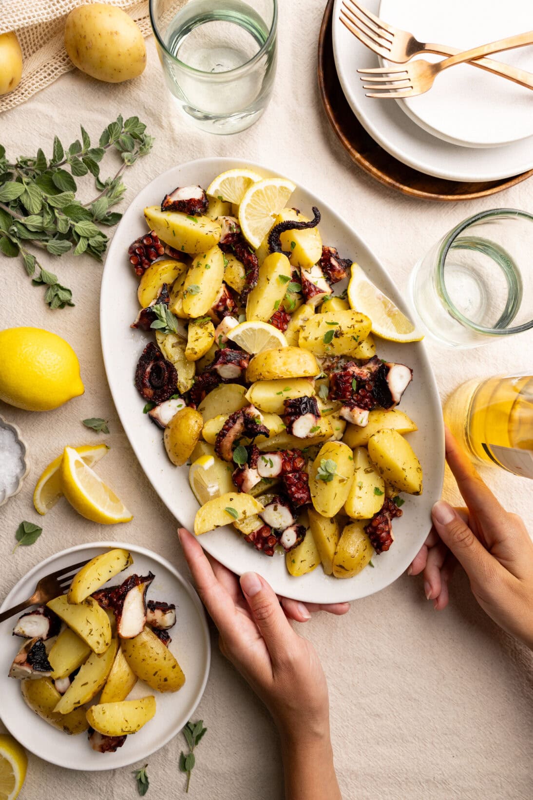 passing a plate of Greek lemon potatoes