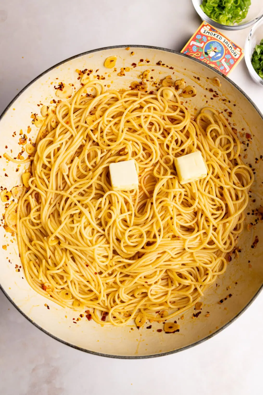 step by step: tossing the pasta with butter and pasta water.