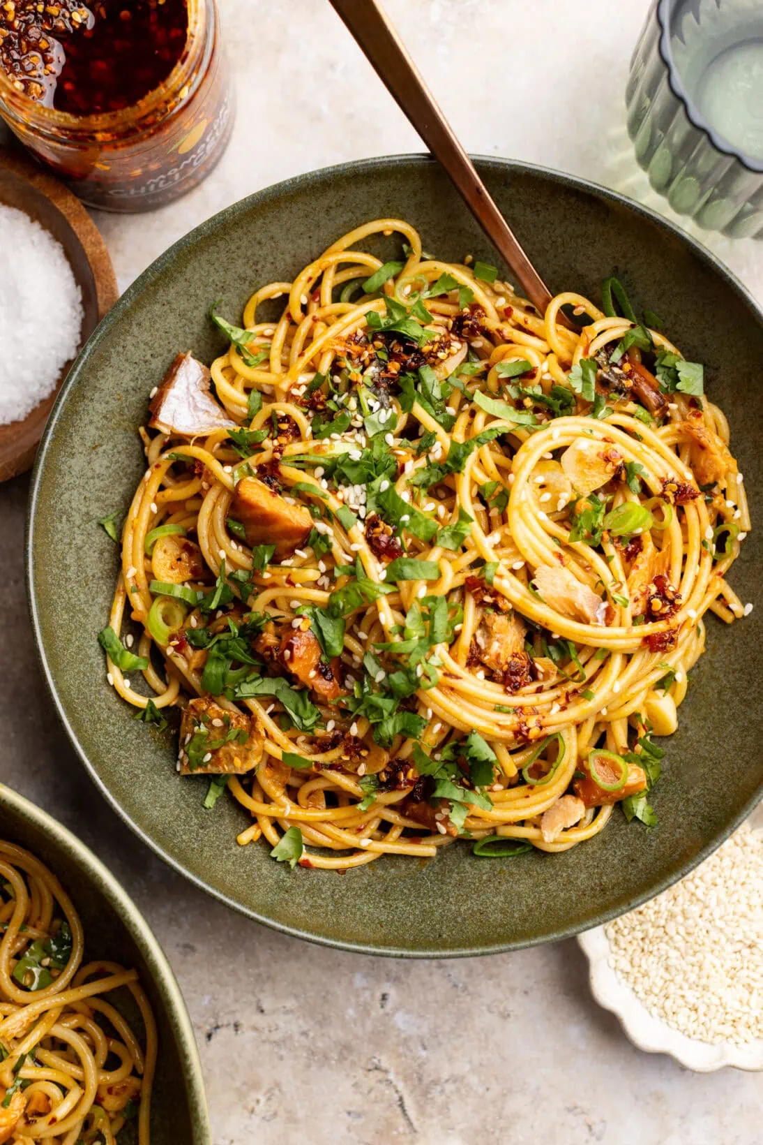 creamy chili crisp pasta in a bowl topped with sesame seeds