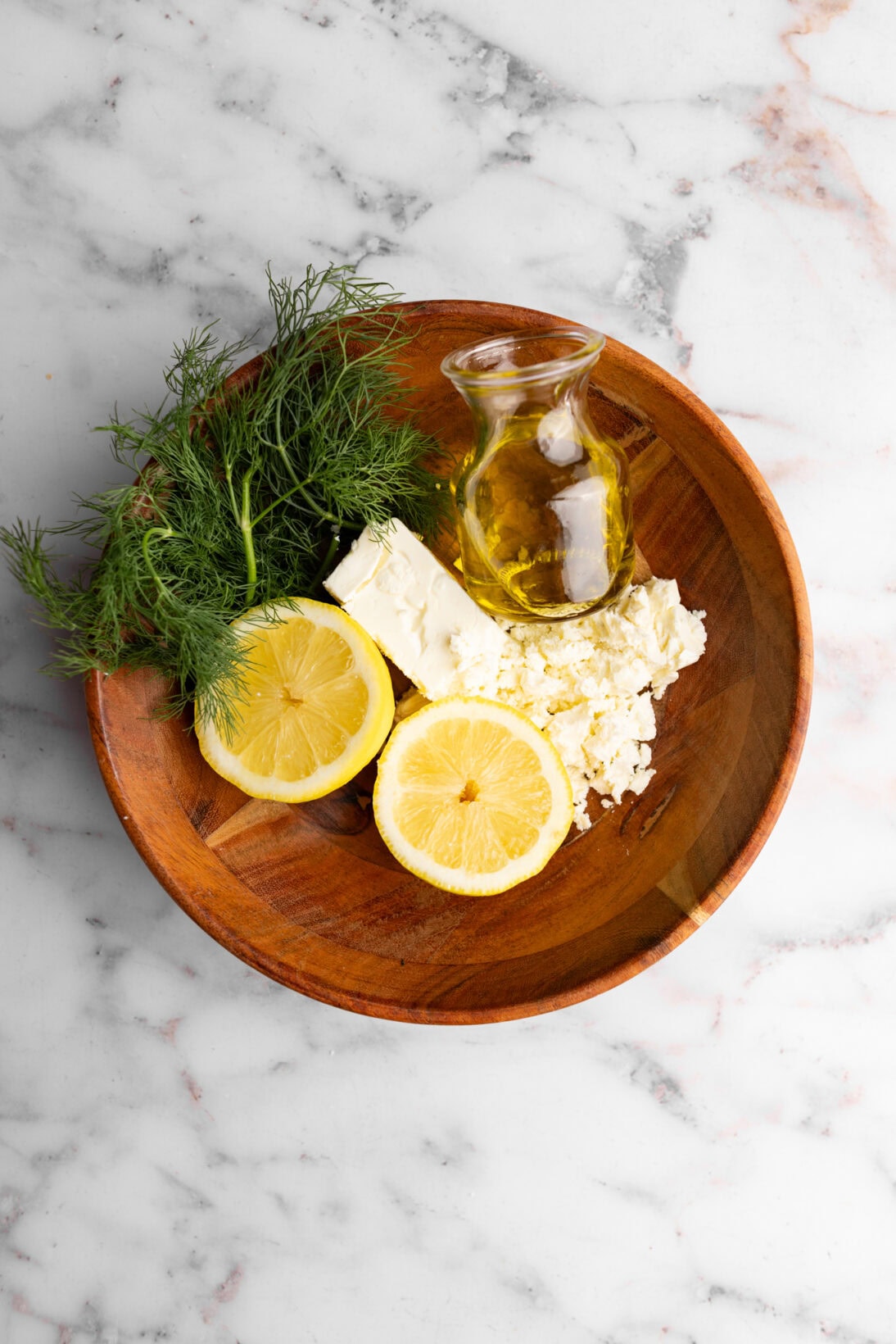 the ingredients for the dressing: feta, lemon juice, olive oil, and dill.