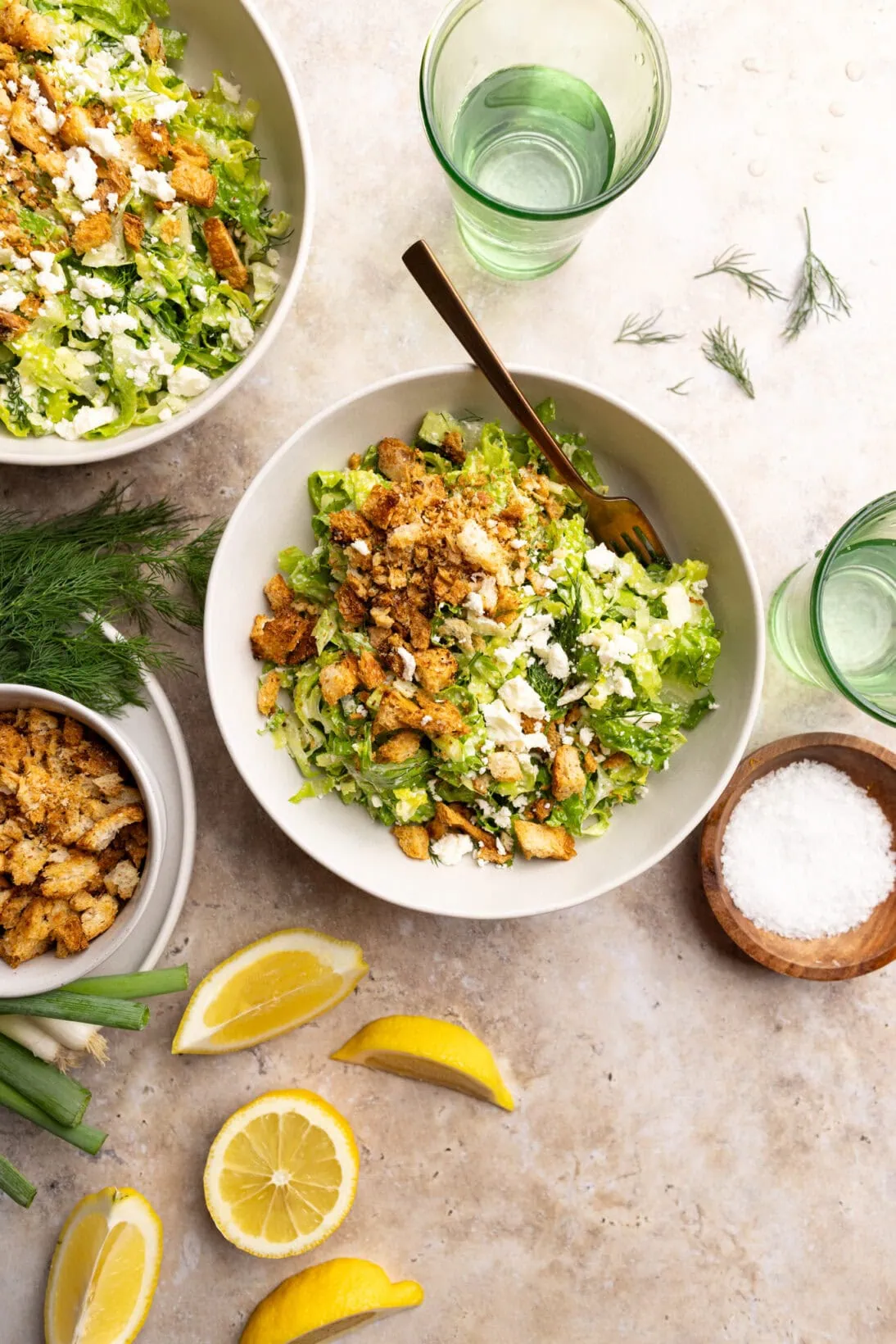 Two bowls of Maroulosalata topped with crispy lemon bread crumbs.