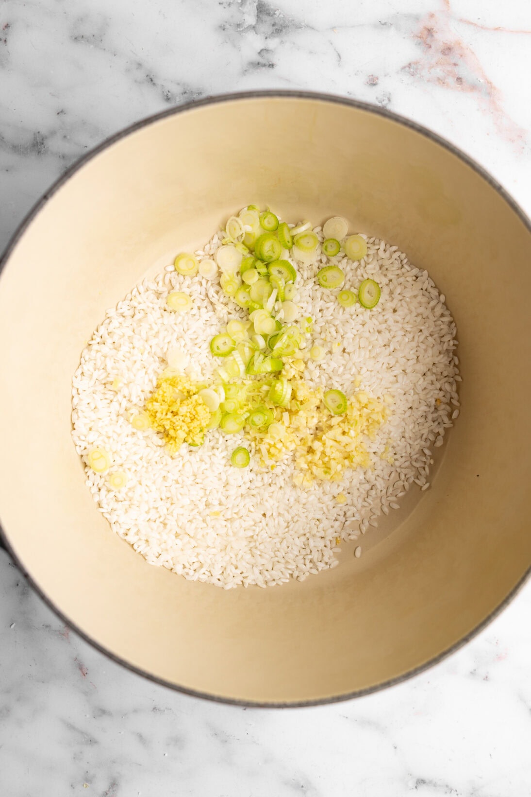 step by step: adding the rice to the pot with the aromatics. 