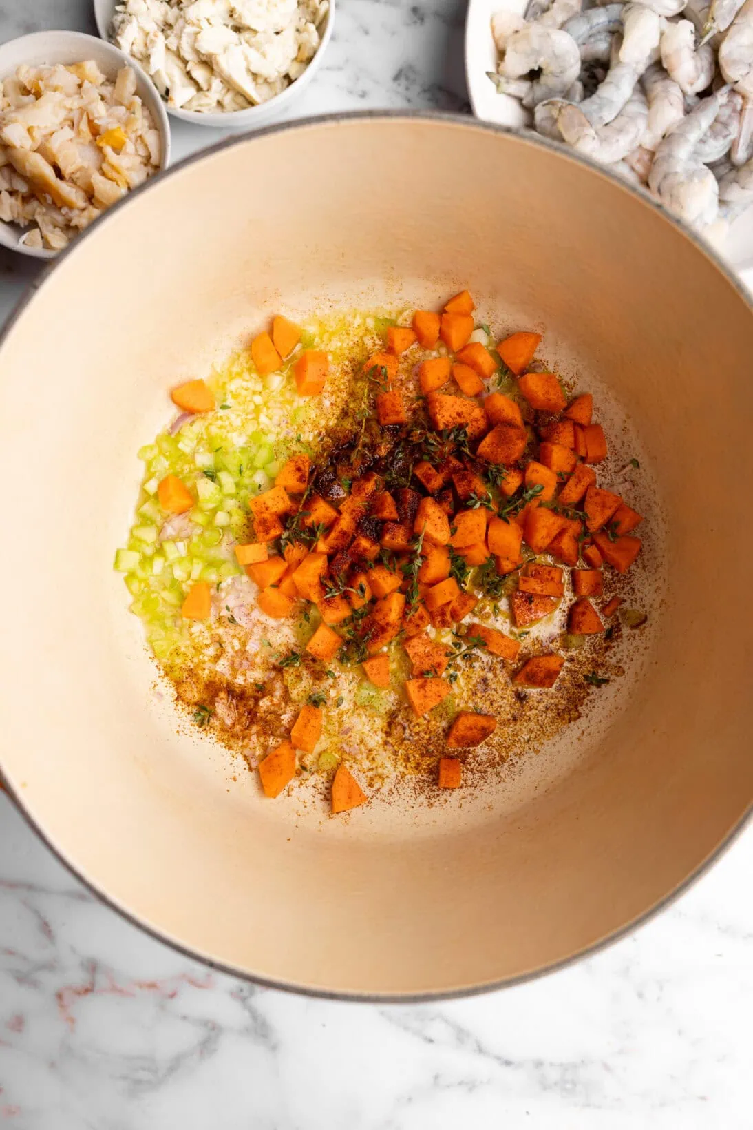 step by step, sautéing the base (garlic, shallot, carrots, thyme and cayenne pepper)