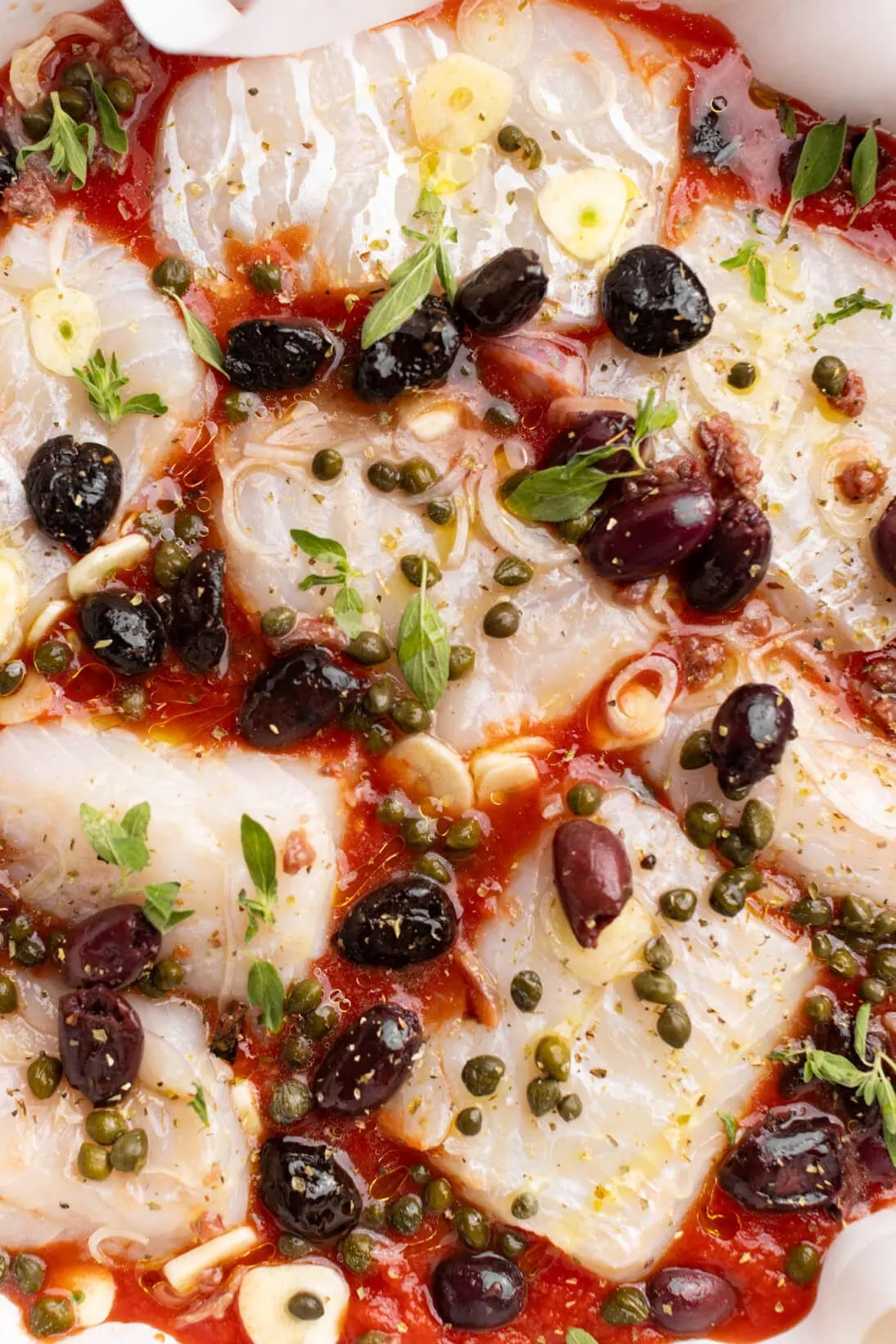 assembled one pot fish puttanesca, uncooked.