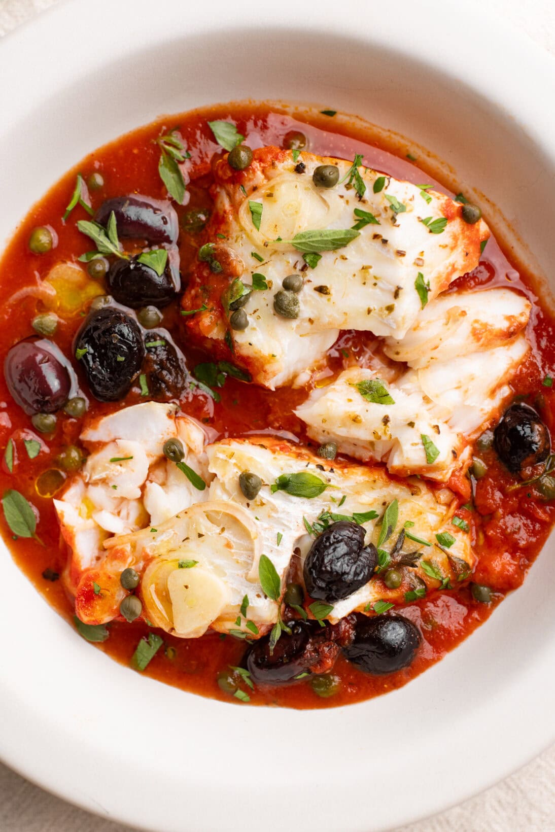 up close bowl of fish puttanesca.