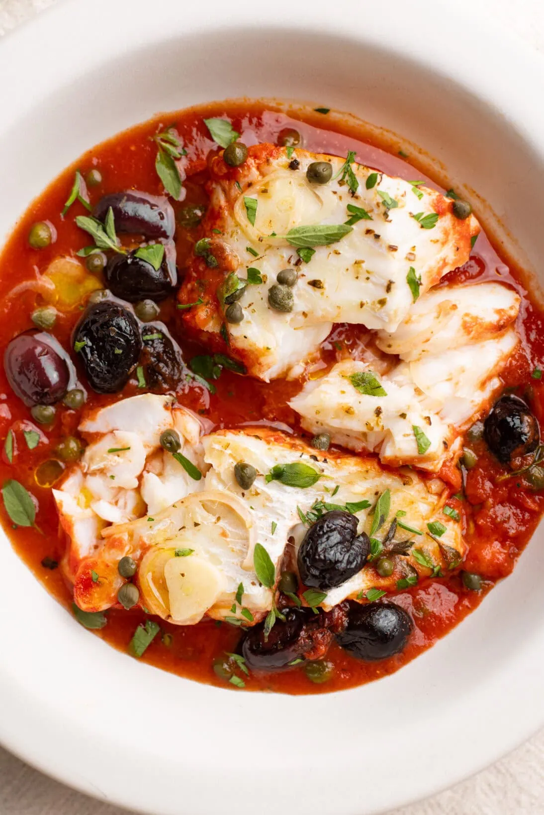 up close bowl of fish puttanesca. 