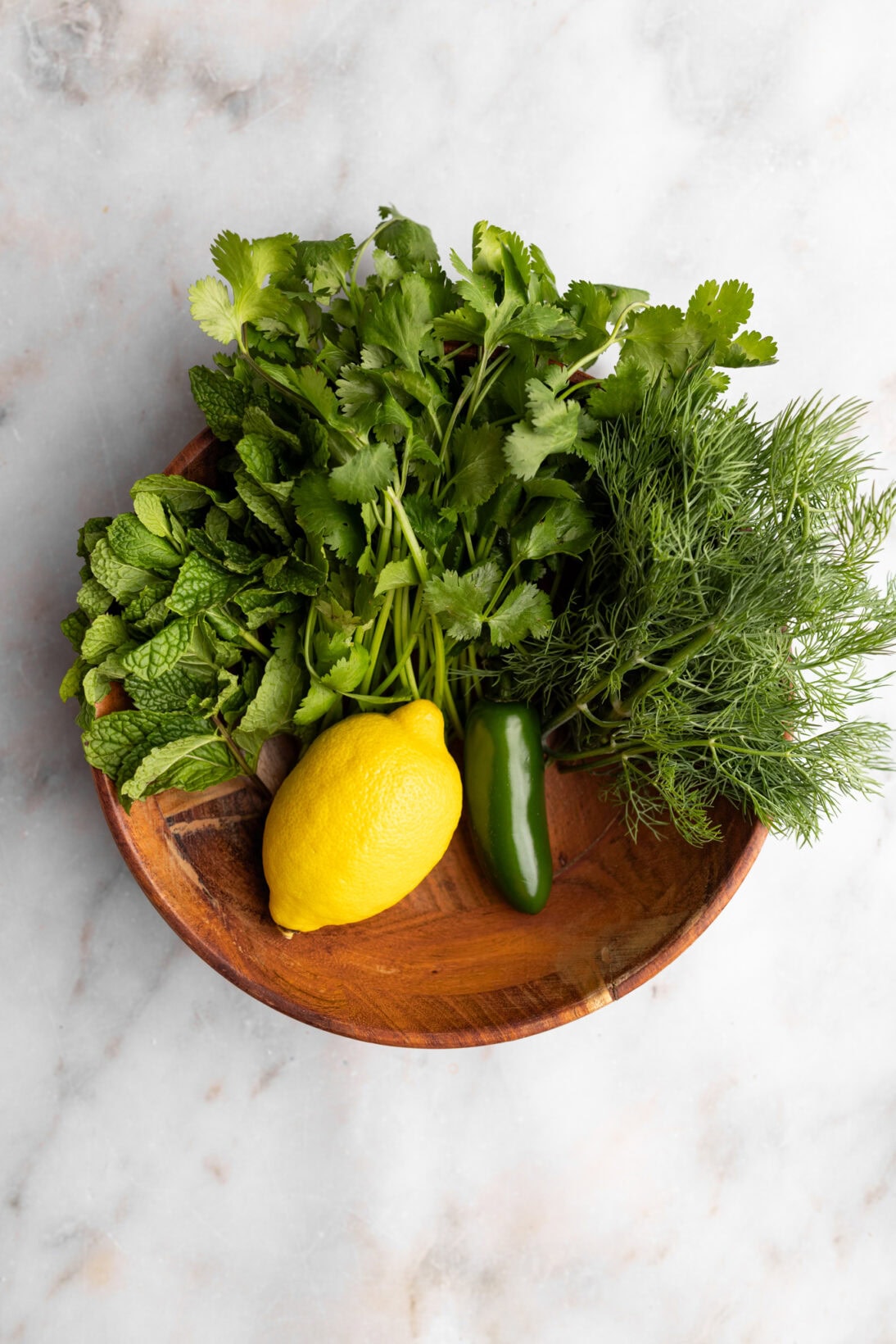 ingredients for the gremolata (lemon, jalapeño, cilantro mint and dill)