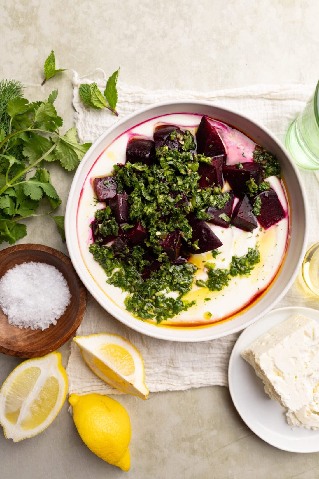 a plate of roasted beets and whipped feta dip topped with the cilantro and mint gremolata.