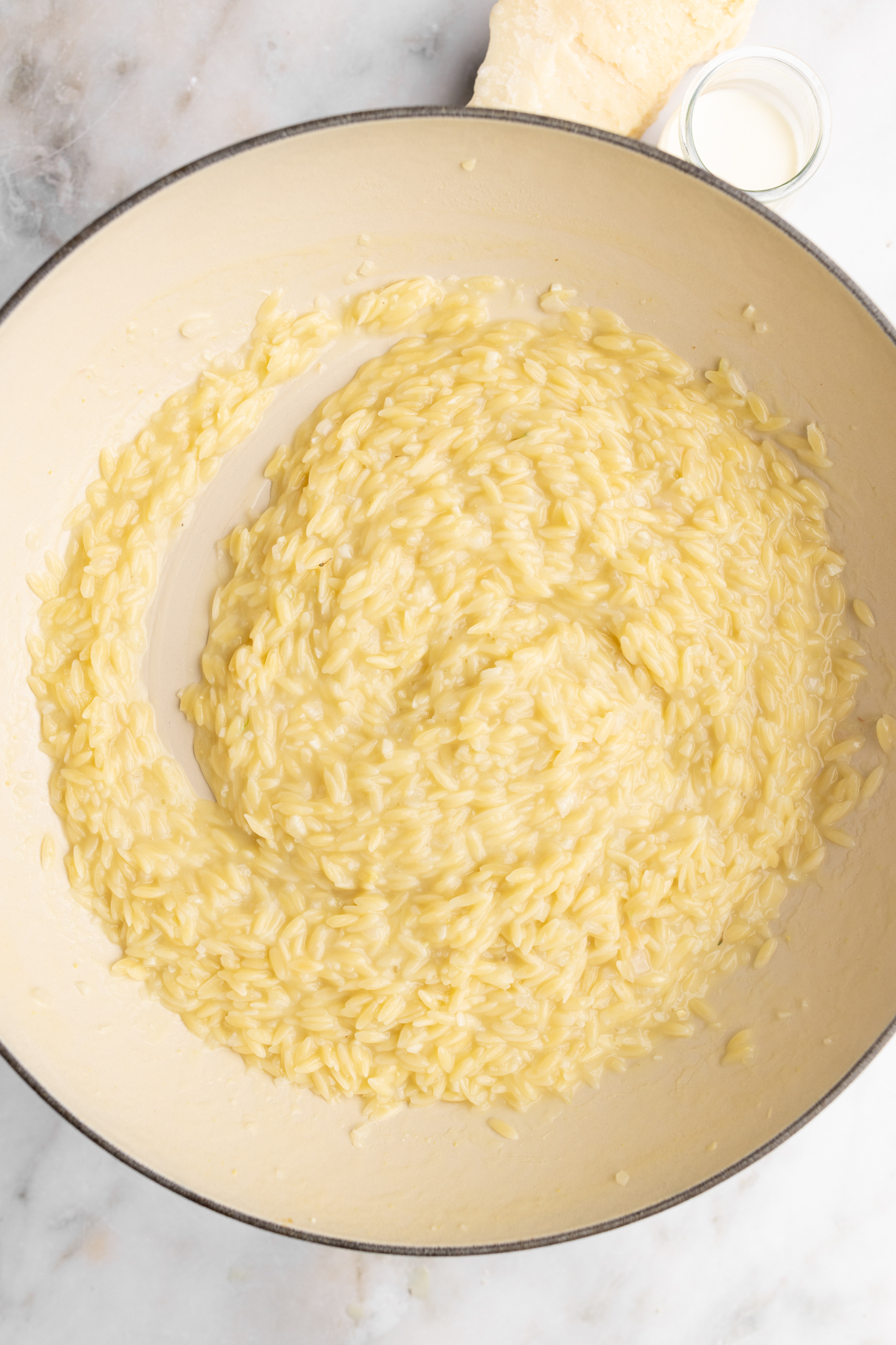 step by step: adding broth in batches.