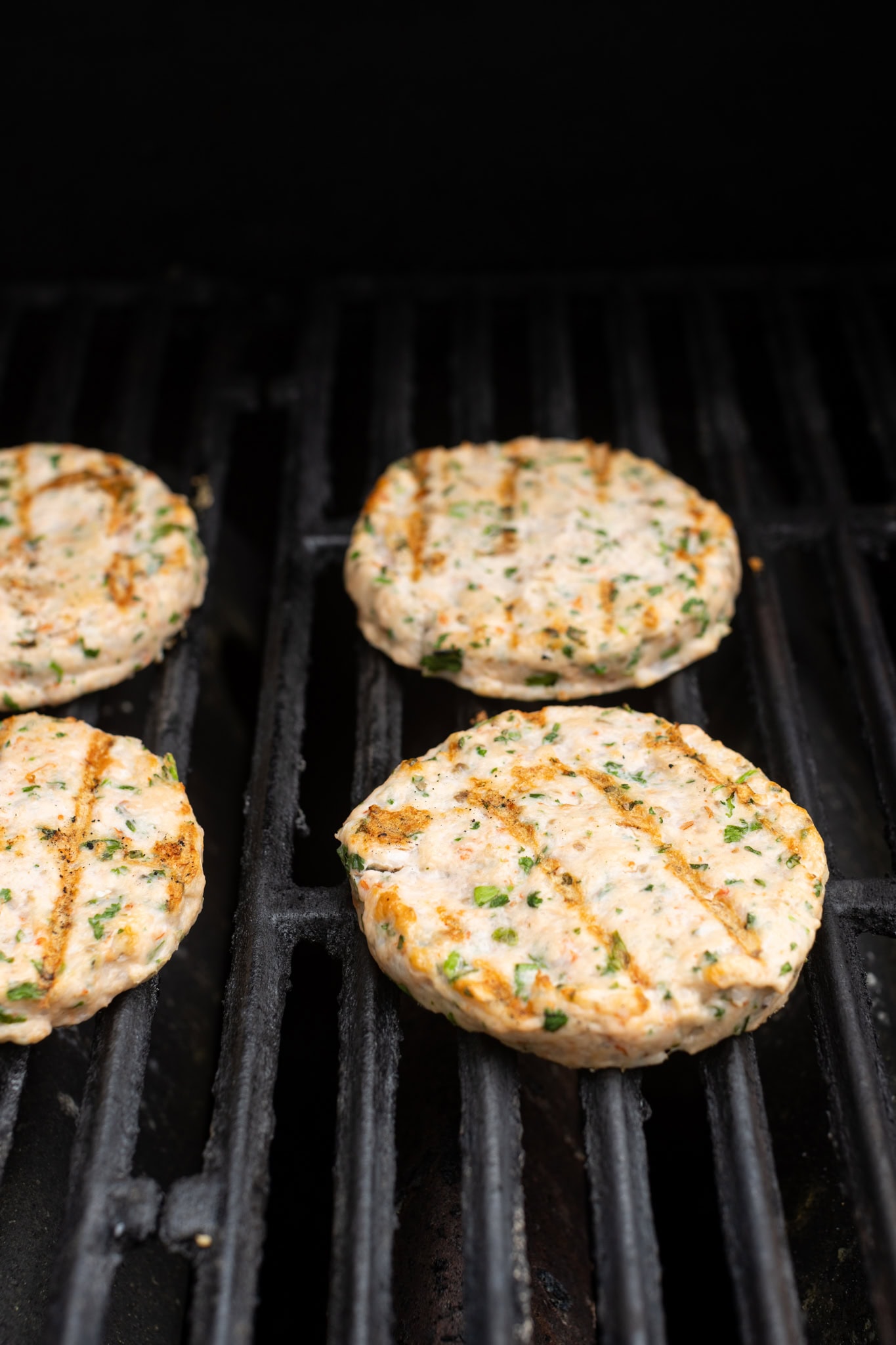 step by step: grilling and flipped burgers.