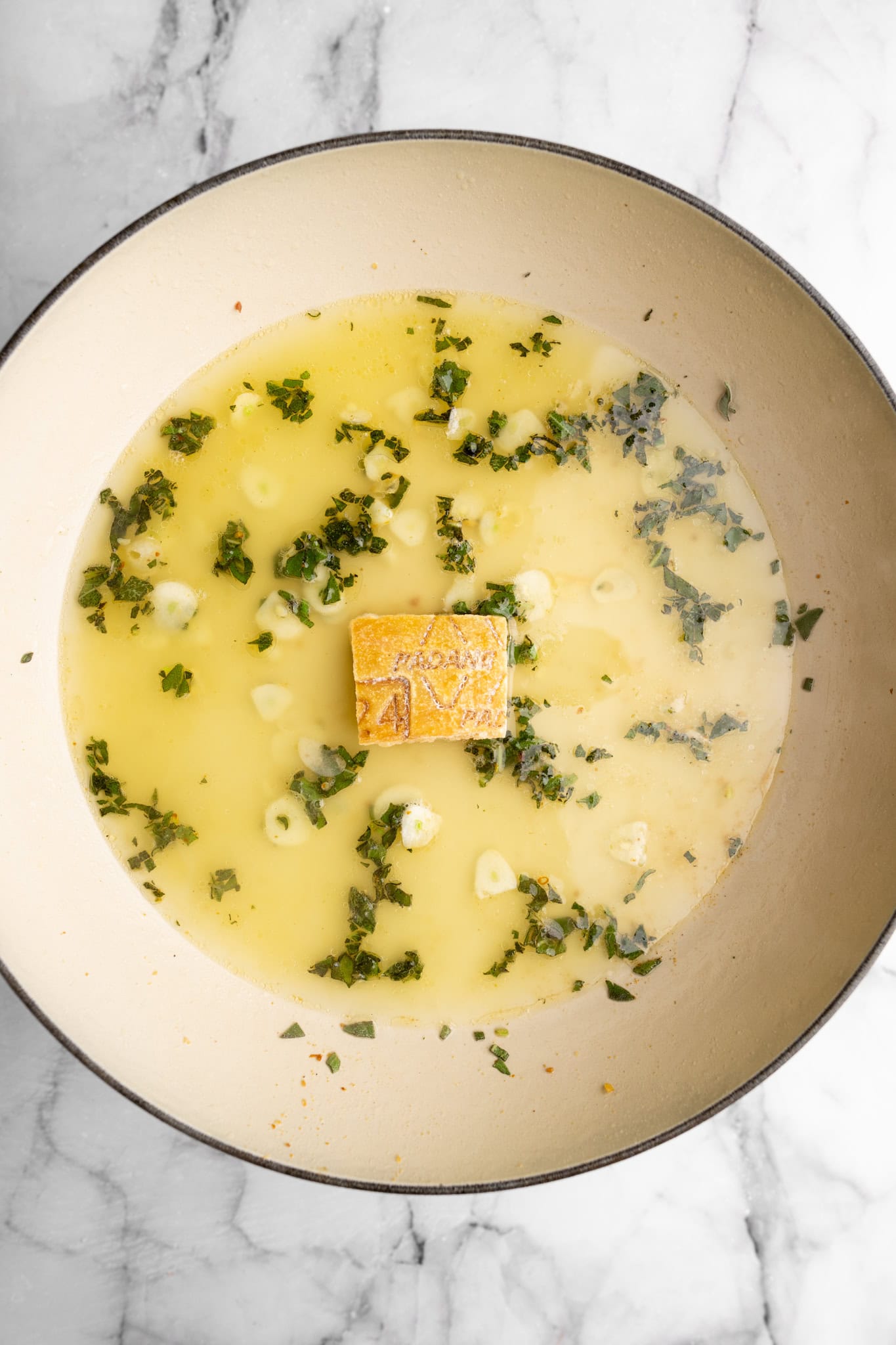 step by step: added in the Parmesan rind and broth