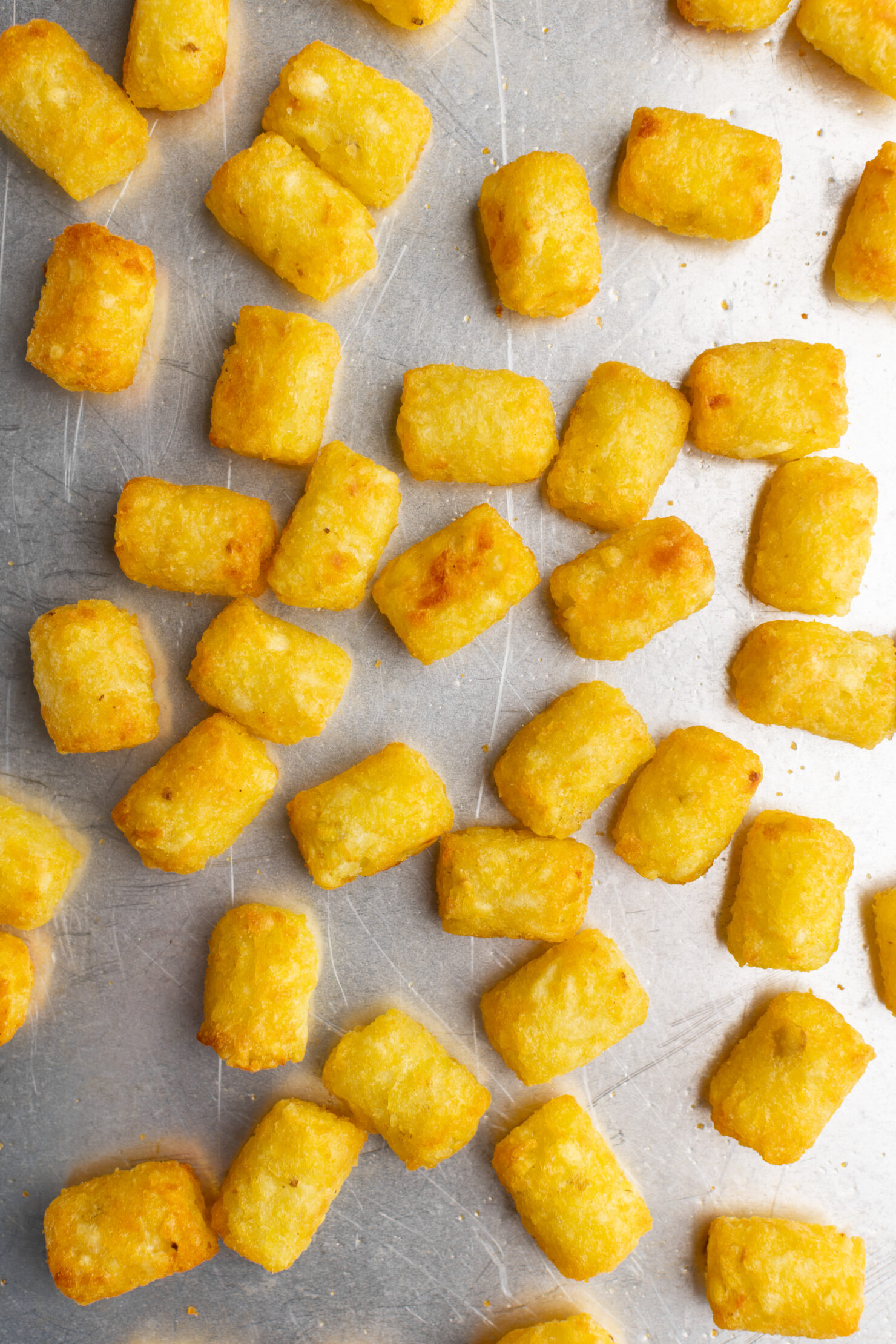 step by step: half cooked tater tots on a sheet tray