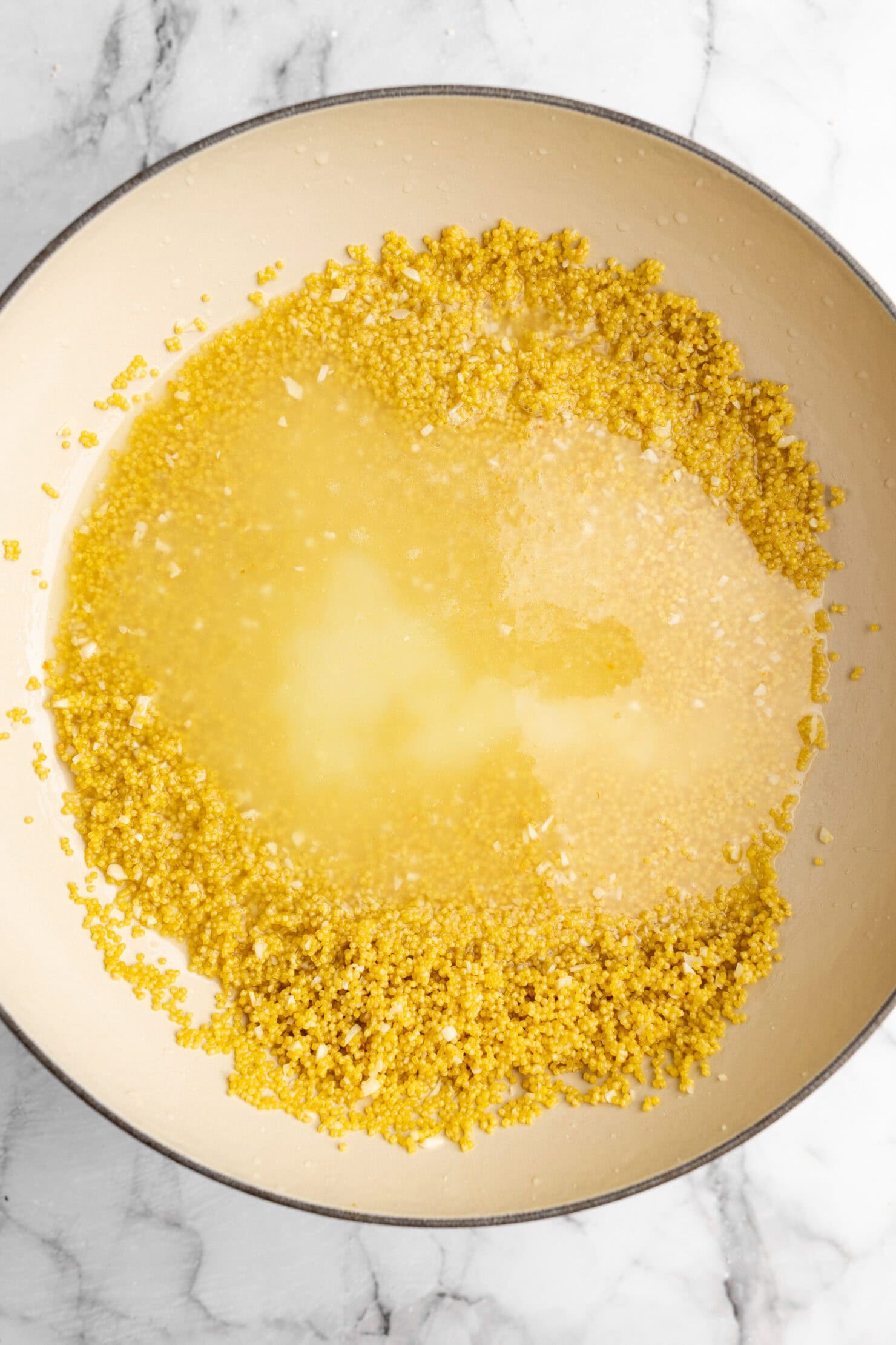 step by step: adding the broth to the pastina