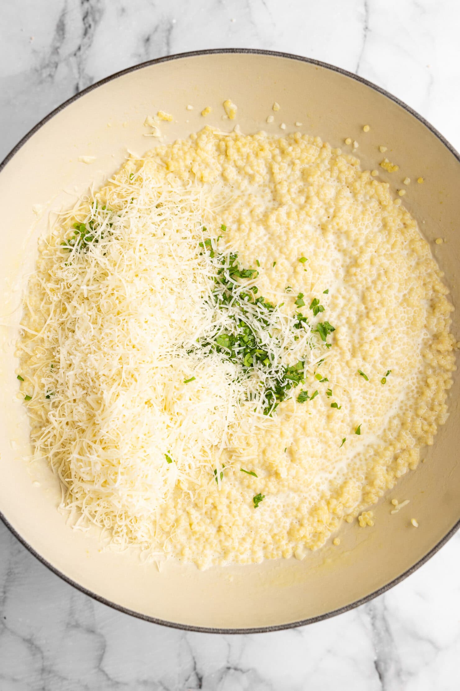 step by step: adding the heavy cream, parmesan cheese and herbs.