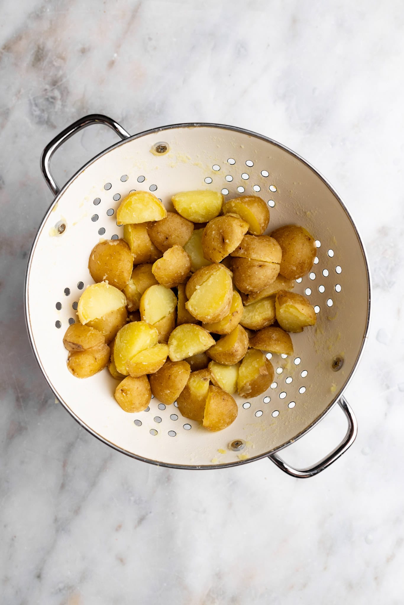 step by step: shaking the potatoes to coat them in starch