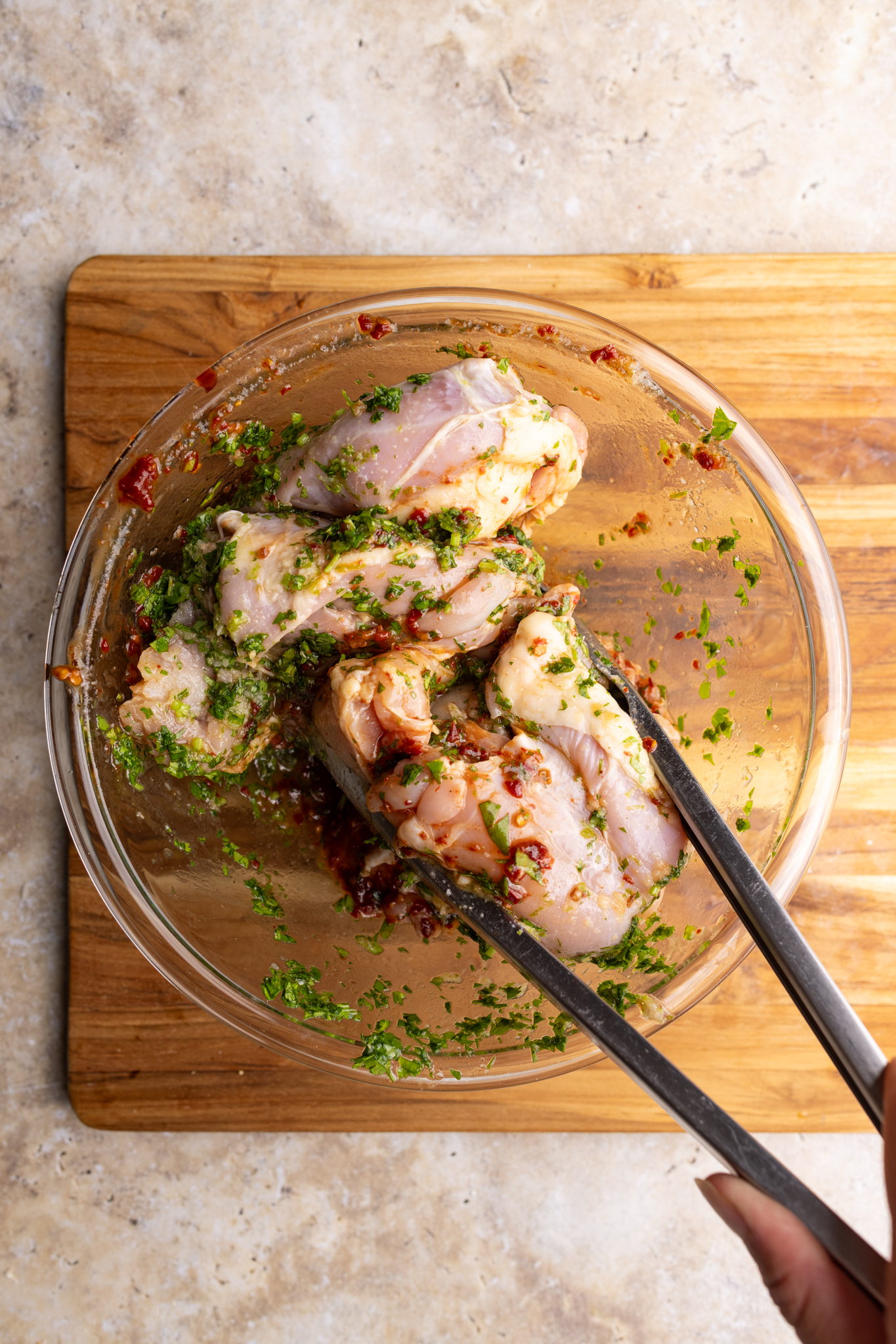step by step: mixing the chicken thighs in the chipotles, cilantro, and lime marinade