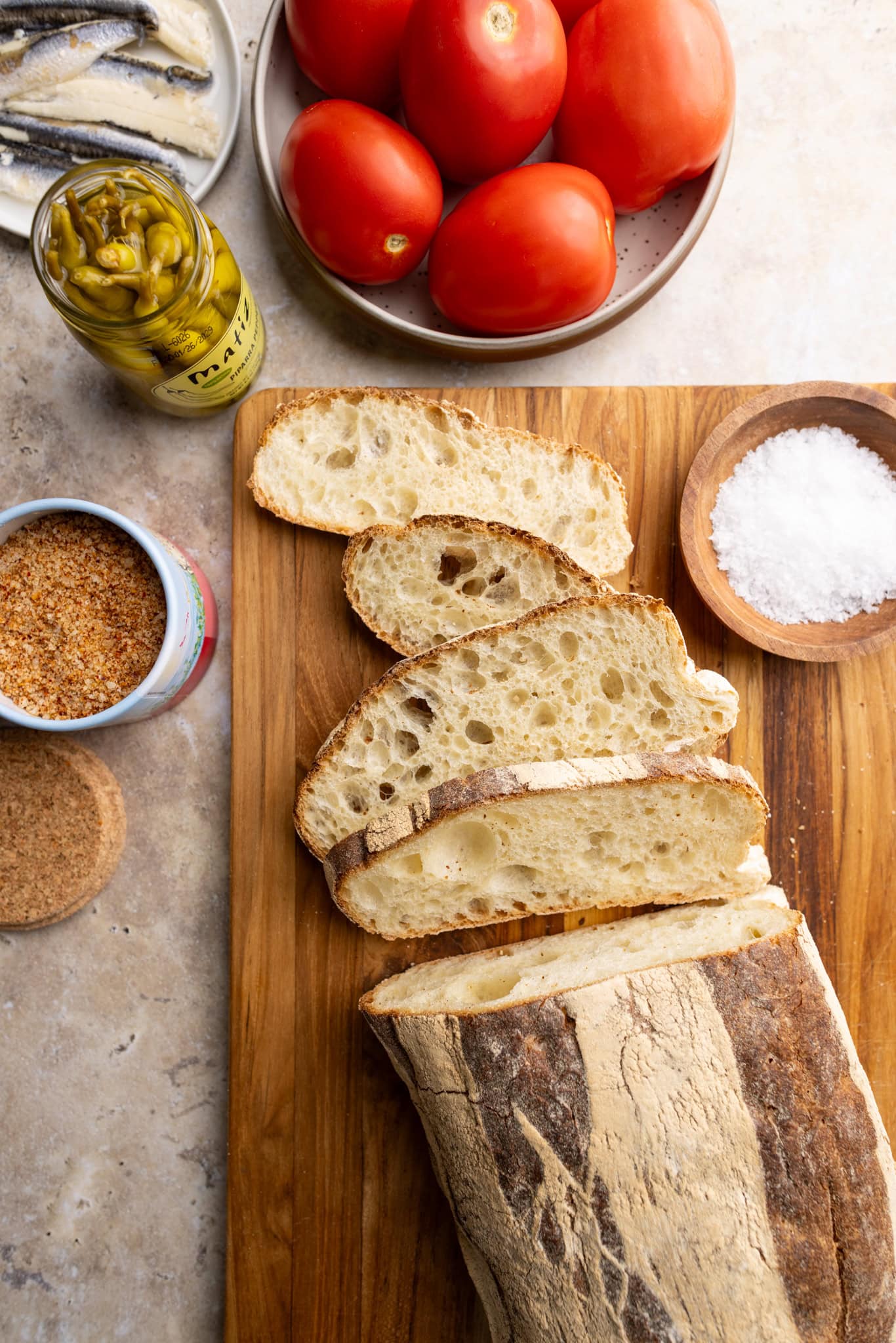 ingredients: sliced bread, tomatoes, seasoned salt, chili peppers and anchovies.