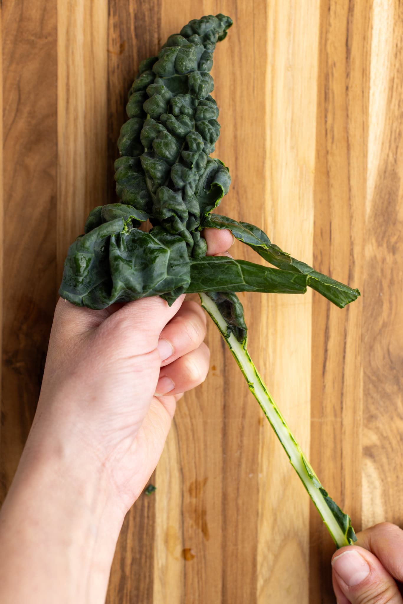 prep photos: de-stemming kale, pinching the stem and pulling up to detach the leaves from the stem.