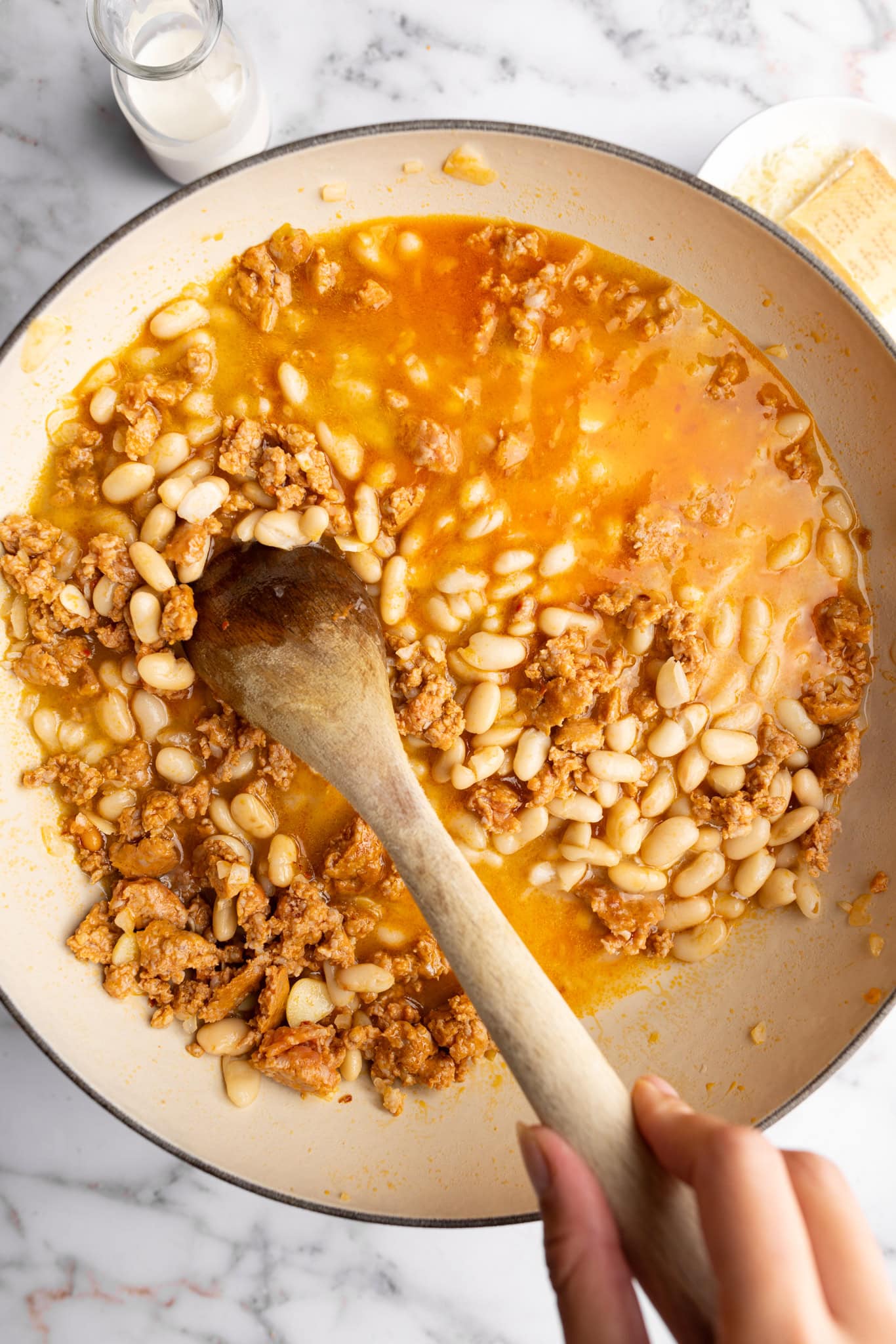 step by step: adding the cannellini beans and broth.