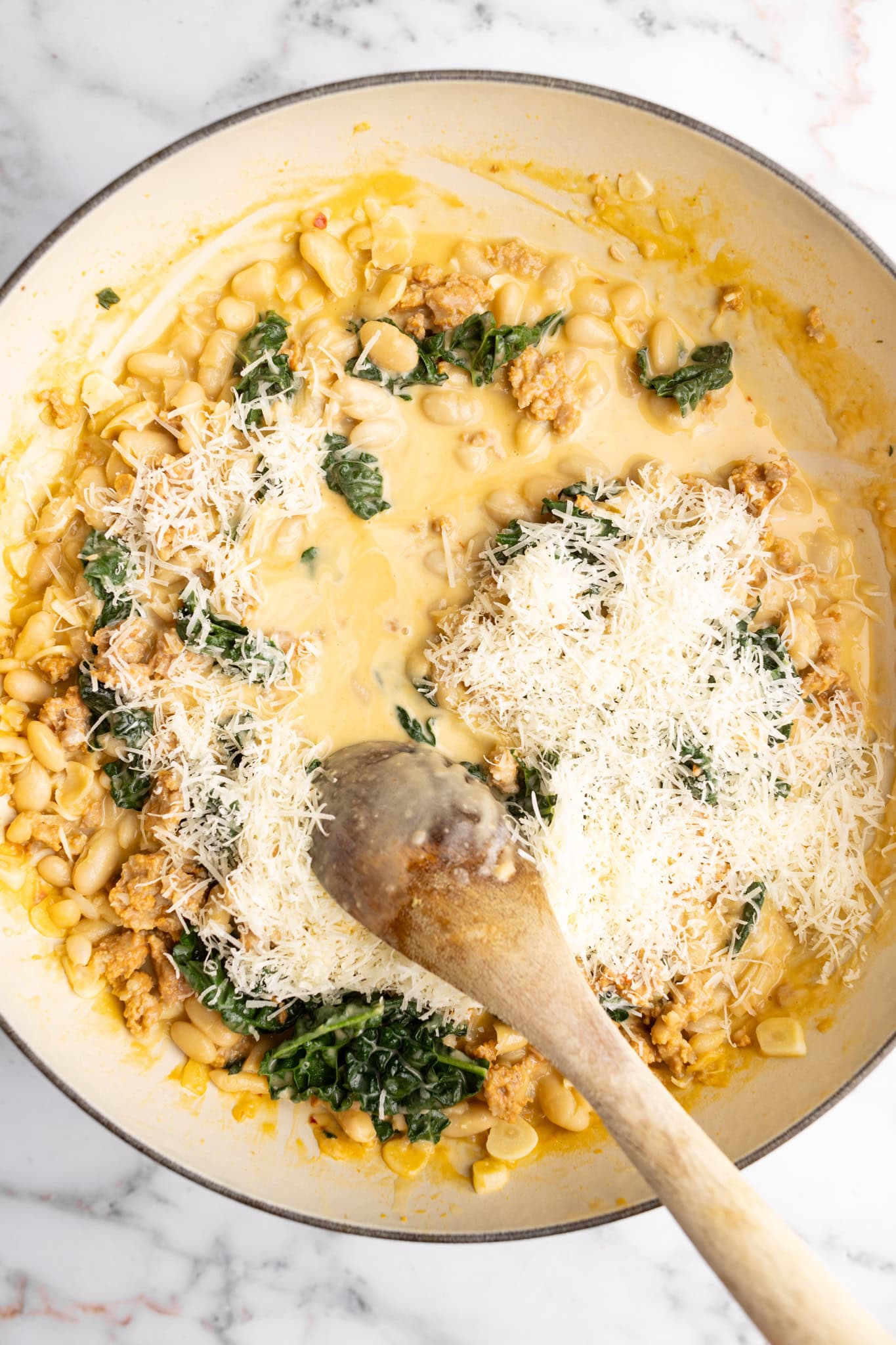 step by step: with the heat off, mixing in the freshly grated Parmesan cheese.